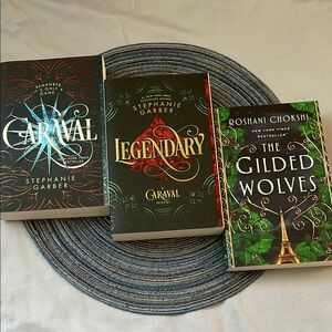 Three young adult fantasy fiction novels | Caraval series and The Gilded Wolves